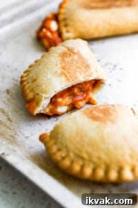 Crispy Air Fryer Frozen Pizza Pops Recipe 7 Side close up view of air fryer pizza pockets cut in half.
