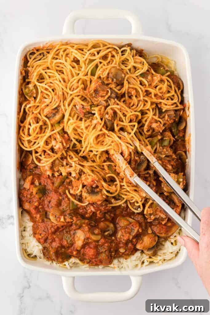 Vegetarian Baked Spaghetti with Mozzarella and Roasted Veggies 15 mixing the spaghetti into the sauce