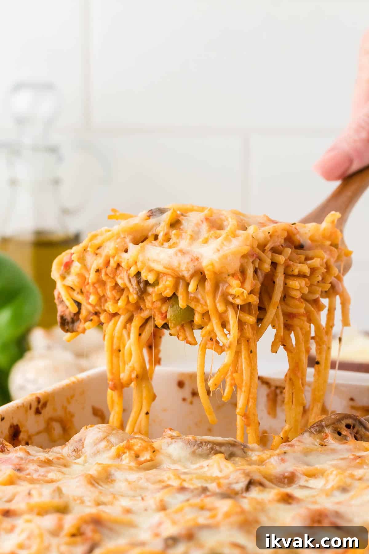 Vegetarian Baked Spaghetti with Mozzarella and Roasted Veggies 23 taking a serving of spaghetti bake from the dish