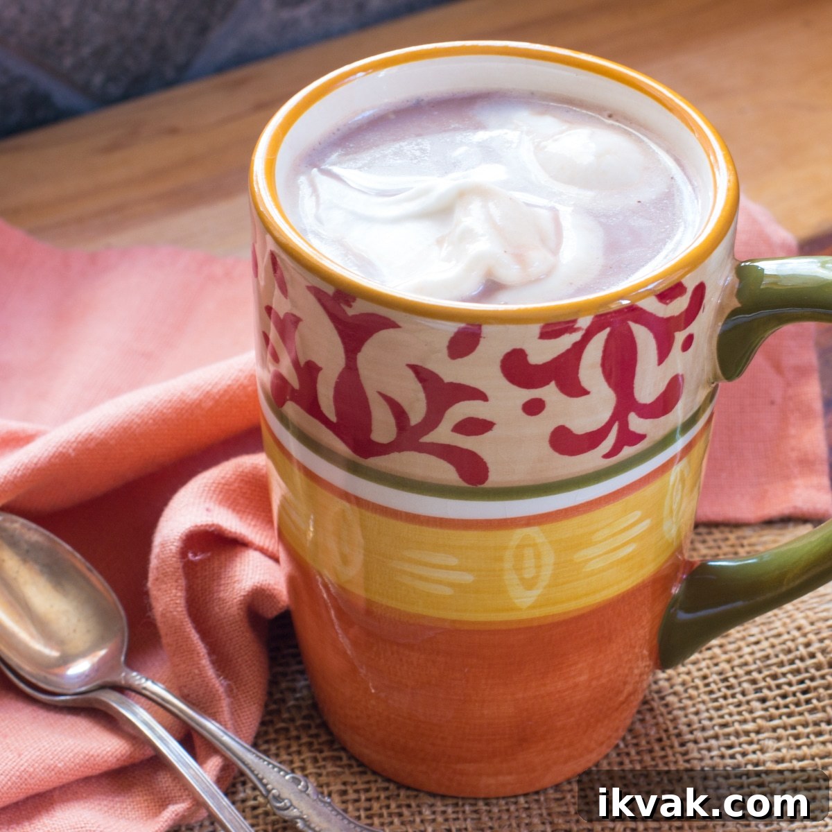 Baileys Hot Chocolate with Coconut Whipped Cream Recipe 2 A cup of hot cocoa topped with coconut whipped cream, and 2 spoons.