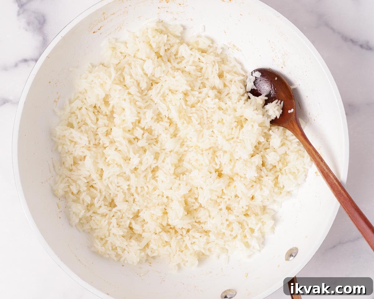 Cooking the rice in the pan with garlic.