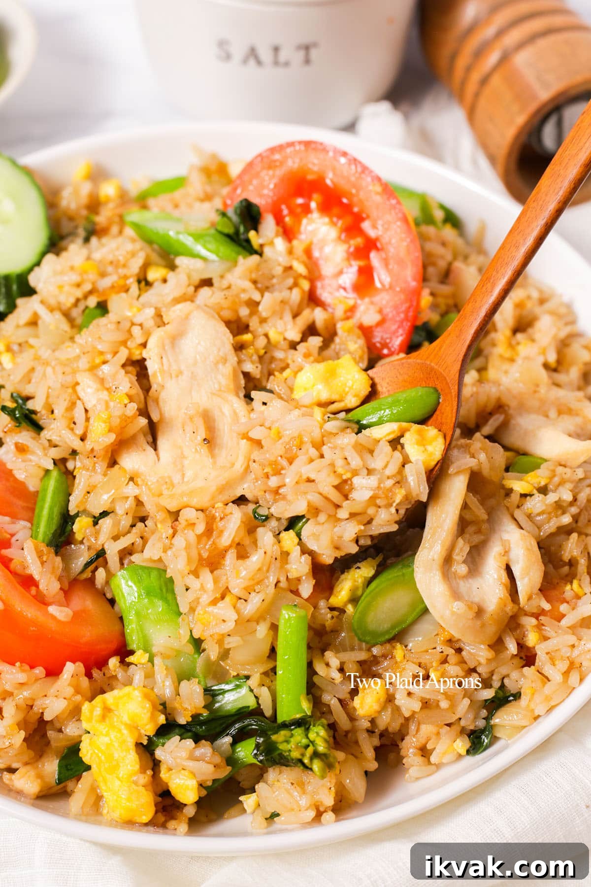 Using a spoon to pick up some Thai fried rice.