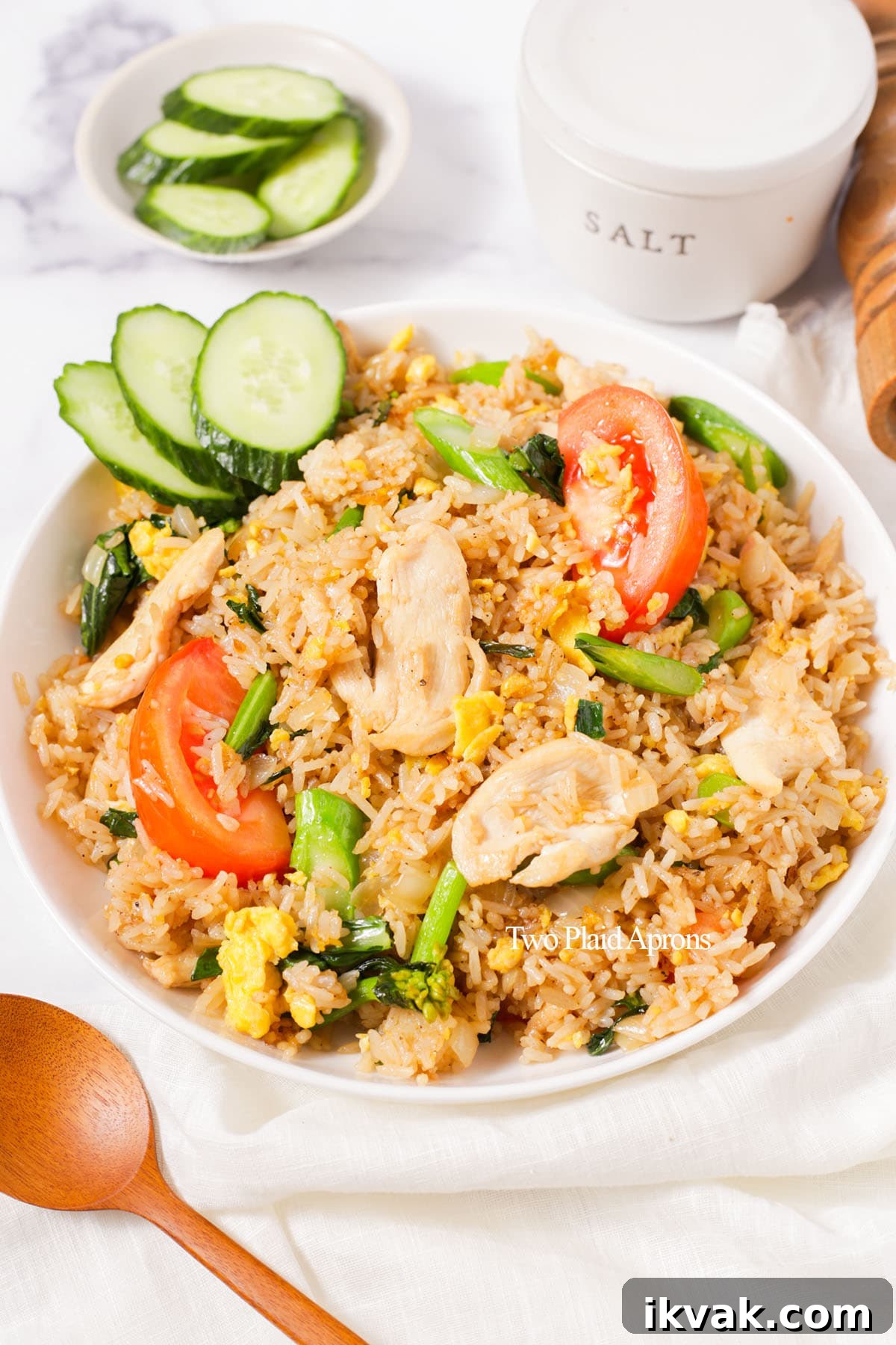 Thai fried rice with sliced cucumbers on the plate.