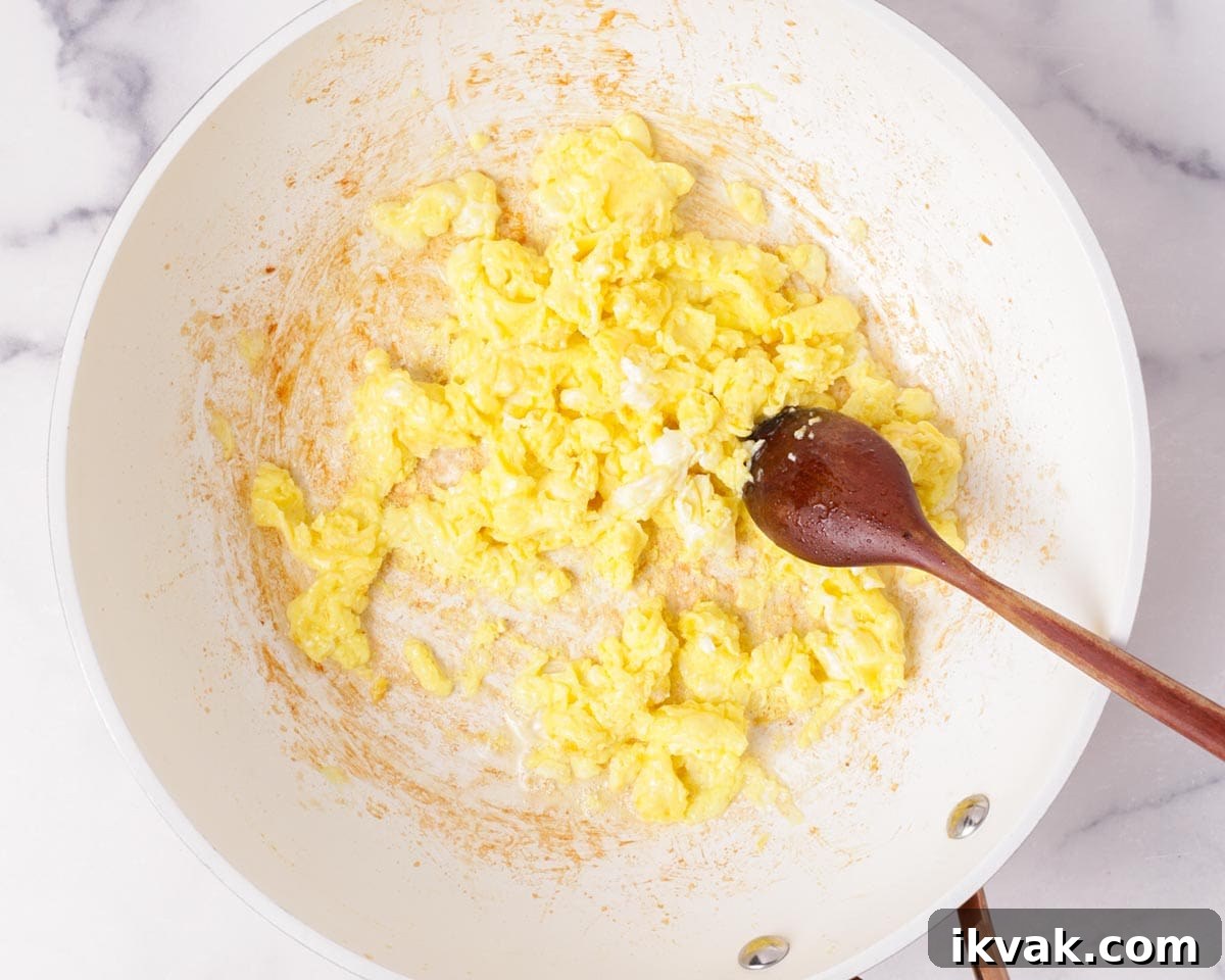 Cooking the eggs in the pan.