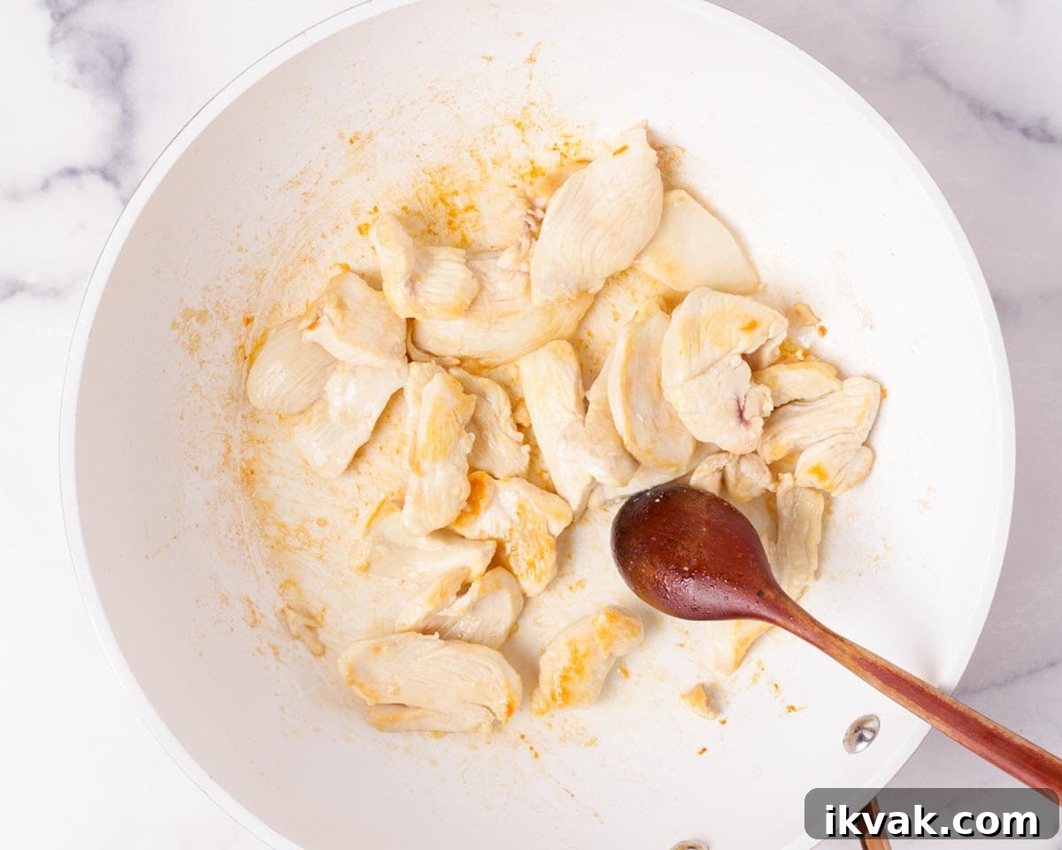 Cooking the sliced chicken breast and seasoned with salt.