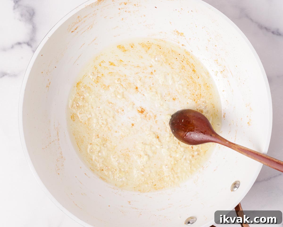 Cooking the minced garlic in oil in a pan.