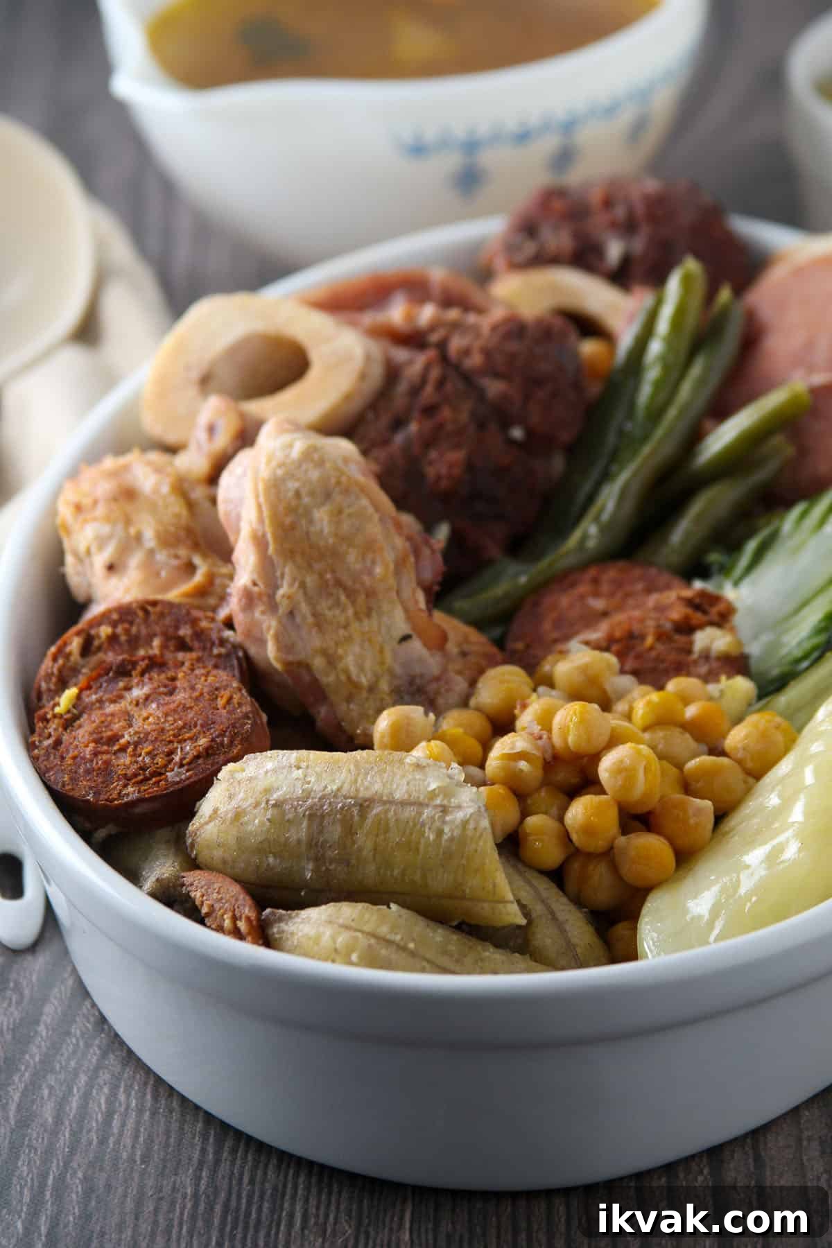 Cocido: Traditional Spanish Stew Recipe and Serving Guide 2 platter of cocido with beef shanks, chicken, ham, saba bananas, Chorizo de Bilbao, pechay