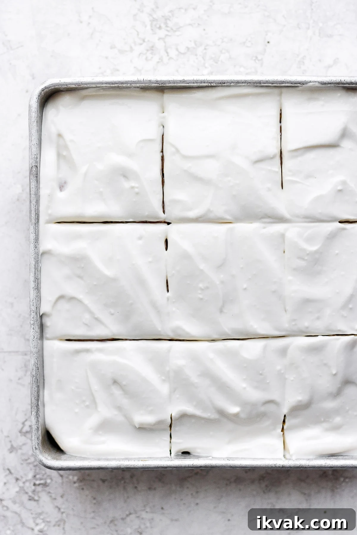 Pumpkin cake sliced with cream cheese frosting.