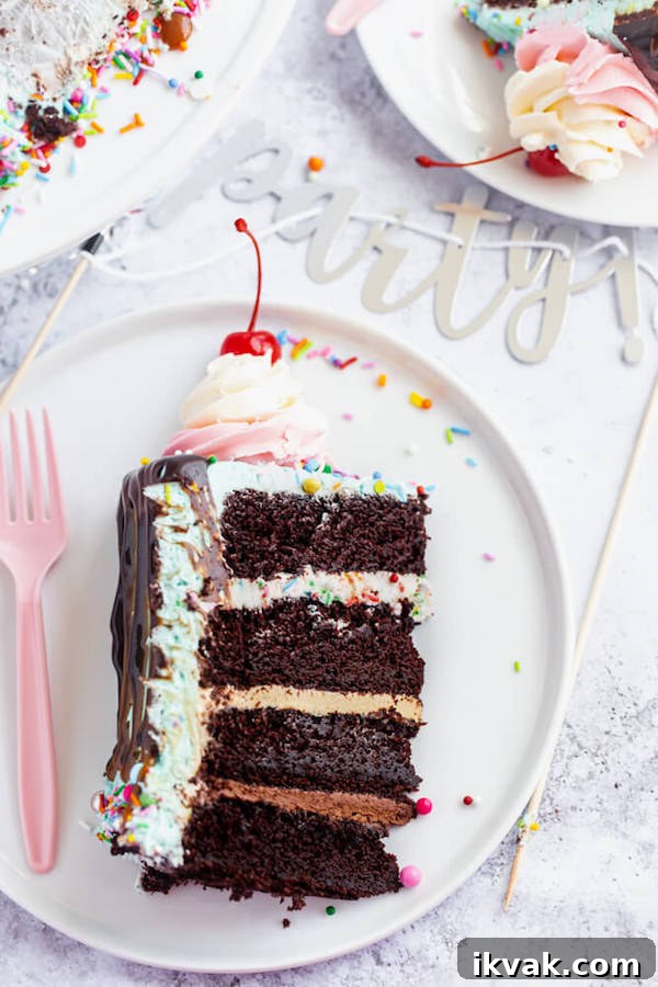 chocolate cake filled with vanilla sprinkle, caramel and chocolate buttercream and covered in a teal sprinkle frosting, topped with maraschino cherries and decorated with more sprinkles.