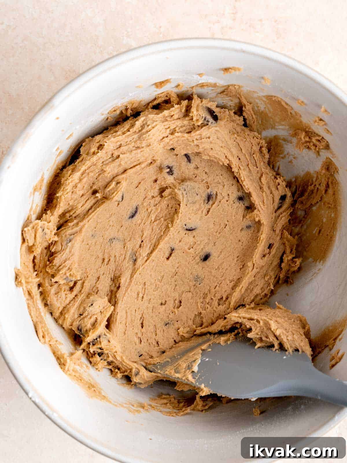 Chocolate Chip Cookies Made with Sourdough Discard 7 Sourdough chocolate chip cookie dough in a bowl with a rubber spatula.