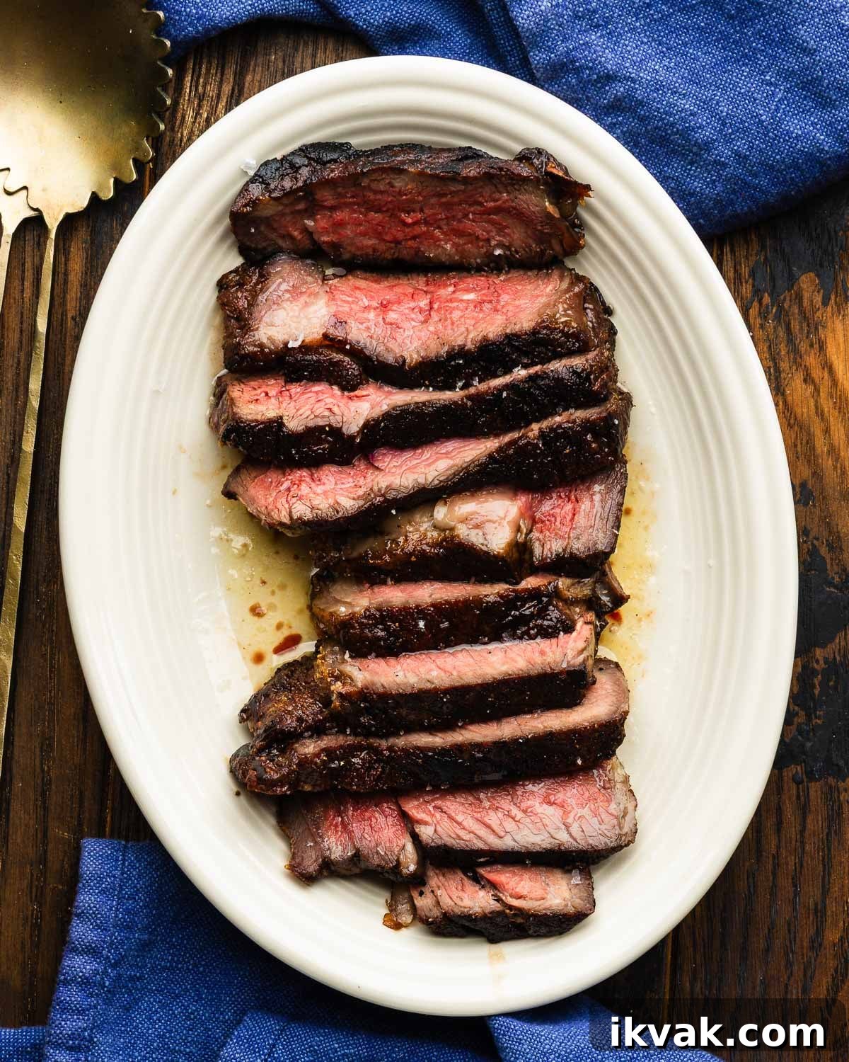 Platter with sliced ribeye steak in butter.