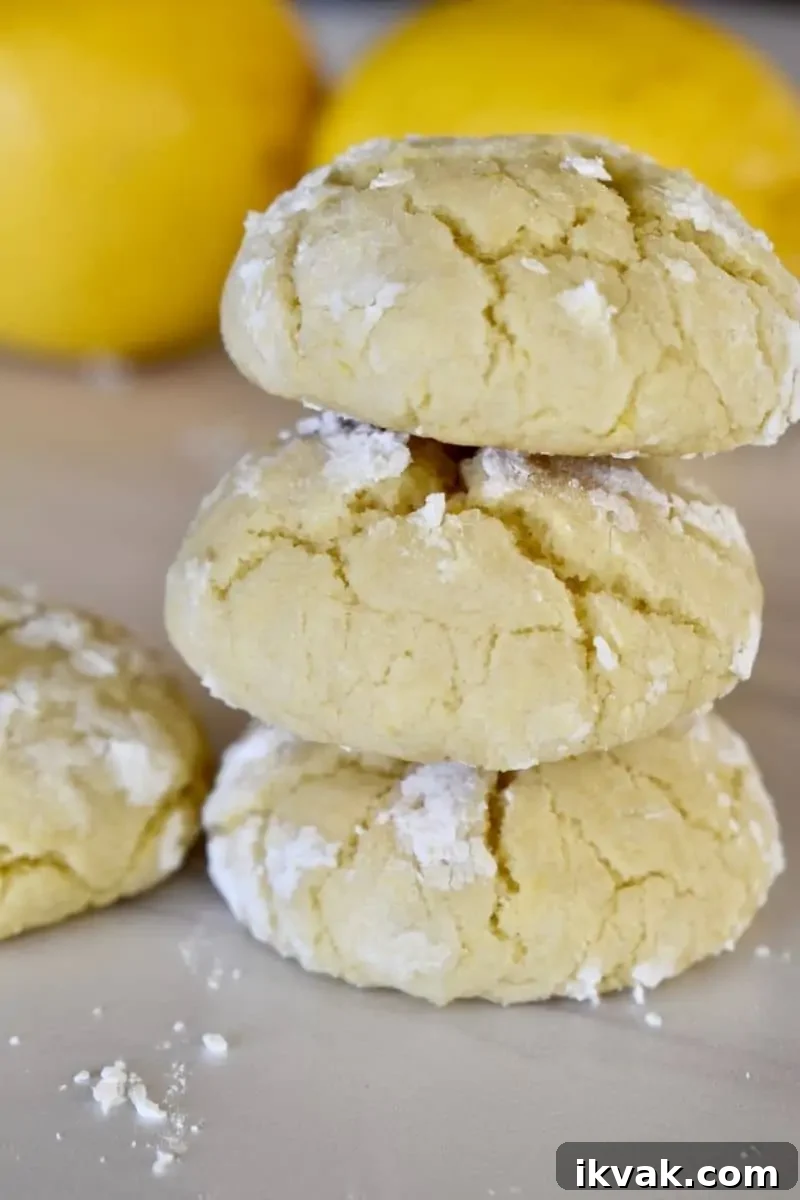 Soft Lemon cookies stacked on each other on a white board. 