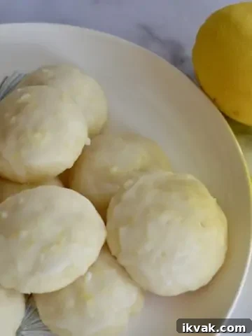 Limoncello Ricotta Cookies on a plate with Limoncello liqueur.