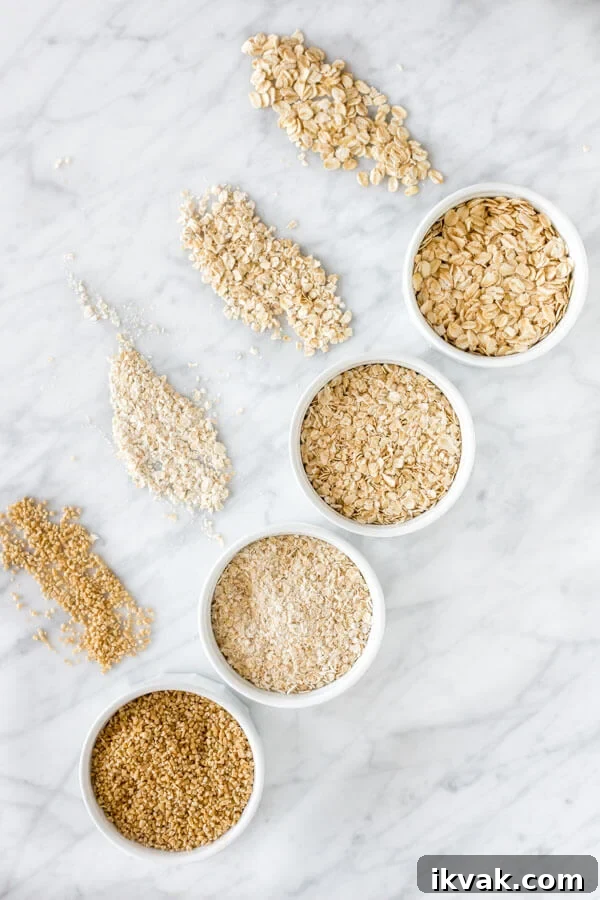 Oat Baking Recipes: Delicious Ways to Bake with Oats 3 Old-fashioned oats, quick, oats, instant oats and steel cut oats displayed top to bottom on a marble surface.