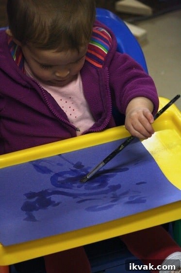 painting with water on construction paper - fine motor art activity for baby