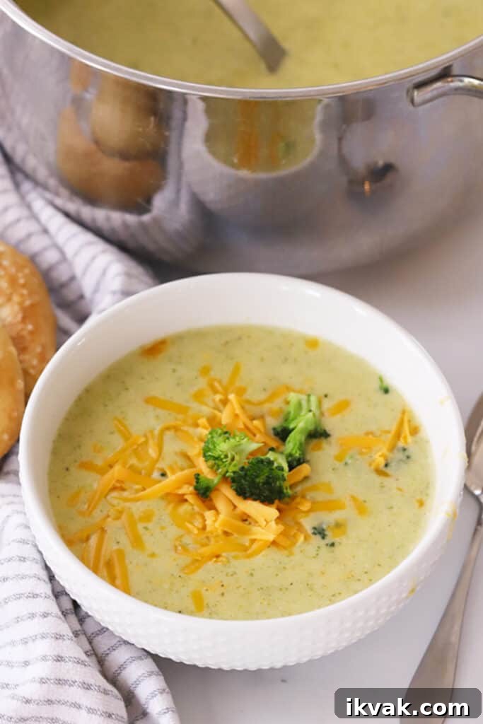 Creamy Broccoli Potato Cheese Soup Recipe for Comforting Meals 4 Broccoli potato and cheese soup in a white bowl.