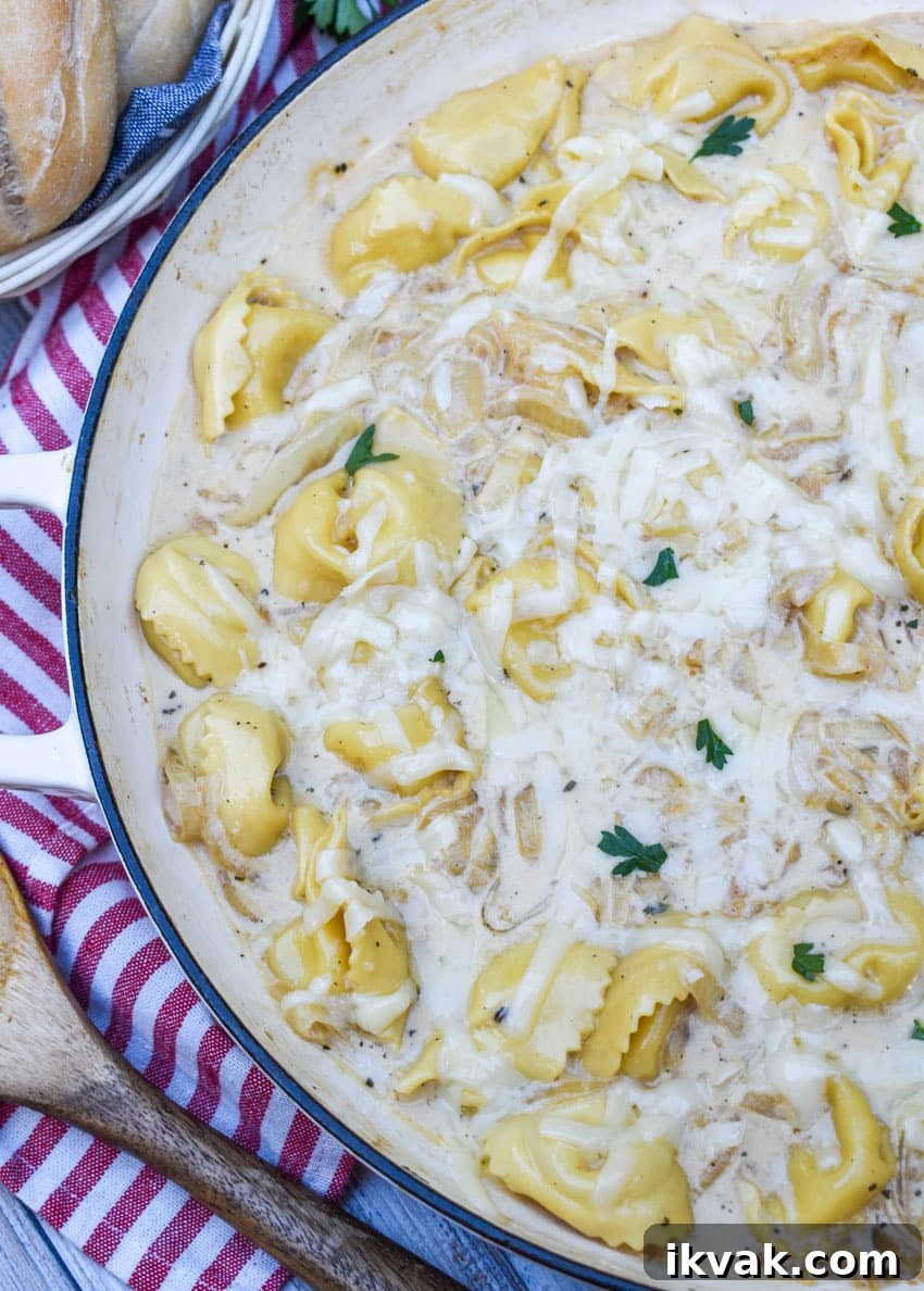 creamy french onion tortellini in a large cast iron skillet
