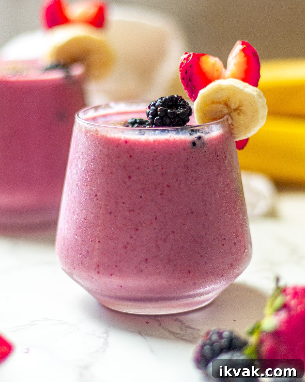 Creamy Blackberry, Strawberry & Banana Smoothie Recipe 3 blackberry strawberry banana smoothie in glasses with fruit garnish