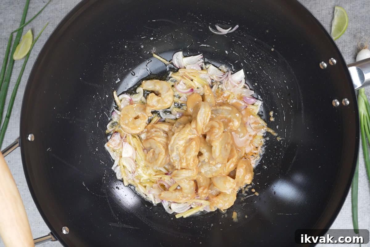 Shrimp Mei Fun (Rice Noodles) Recipe: Authentic Cantonese Stir-Fry 5 Shrimp added to the pan.