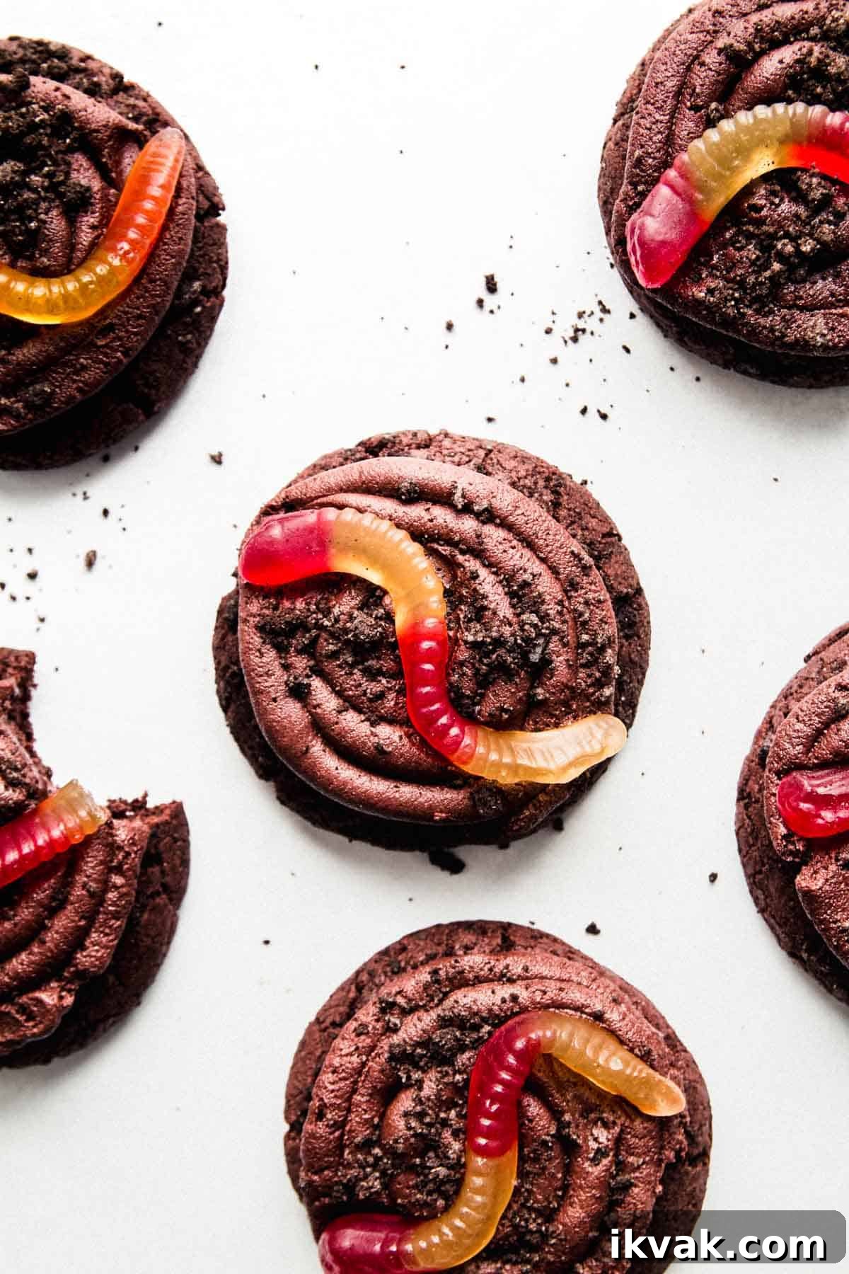 Gluten-free Oreo dirt cookies topped with a swirl of chocolate frosting, Oreo crumbles, and a gummy worm.