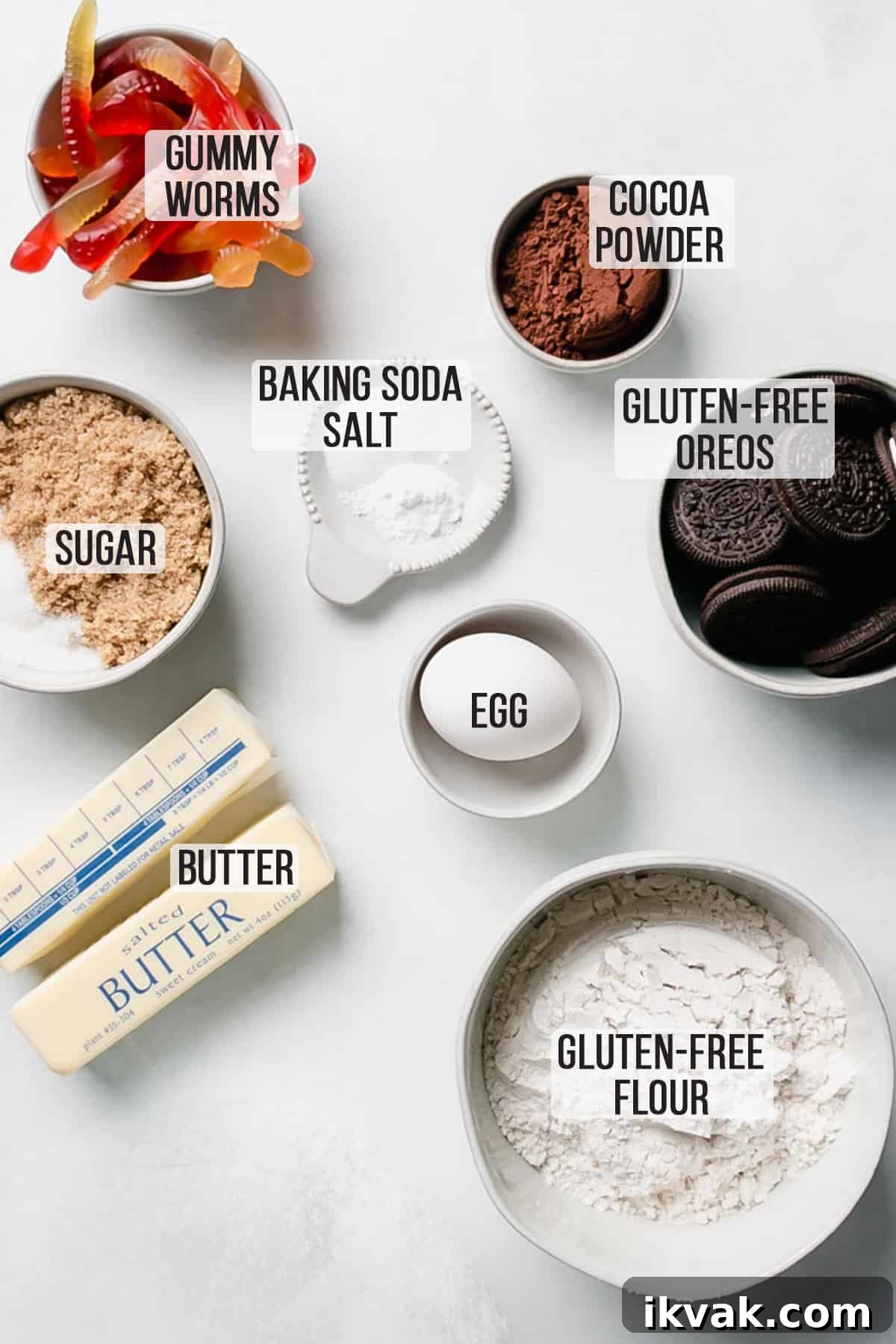 Ingredients for the cookies measured out in bowls on white surface.