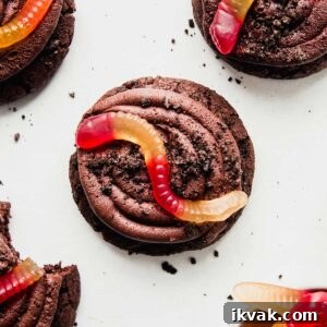 Gluten-Free Oreo Dirt Cake Cookie with a gummy worm on top.