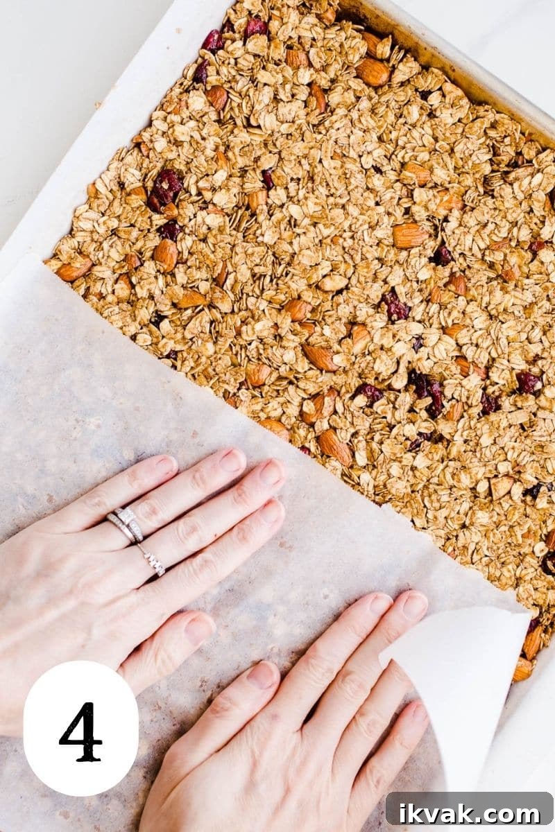 Raw granola being pressed into a pan. 