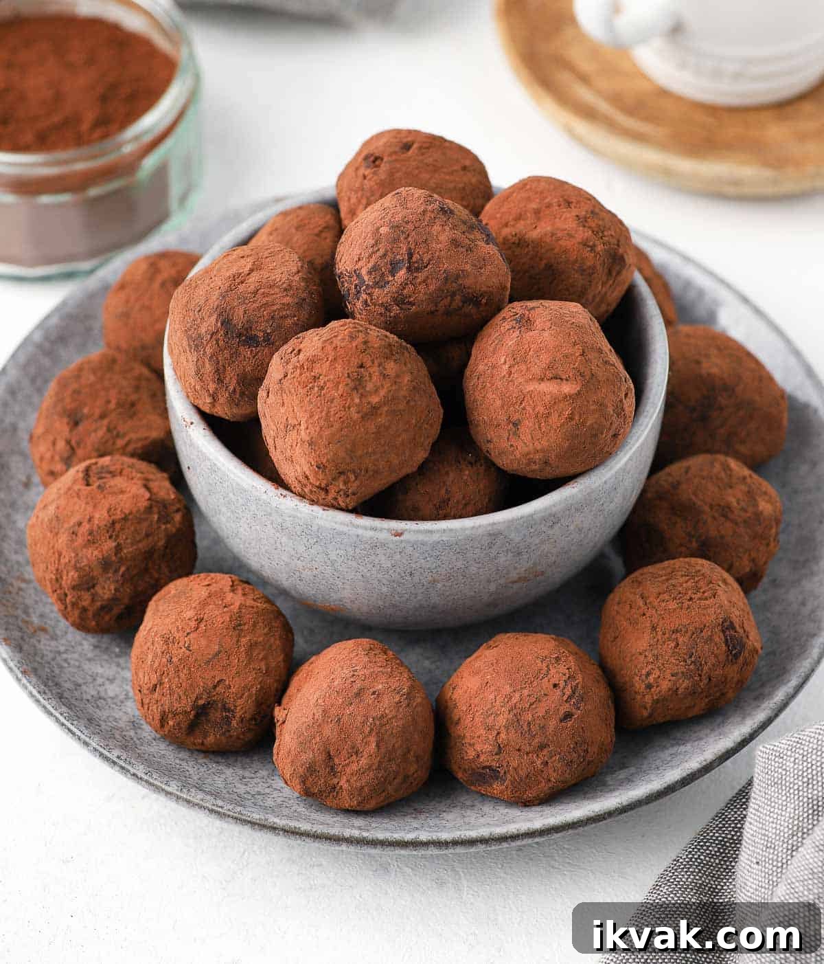 Truffles placed in a grey bowl over a grey plate.