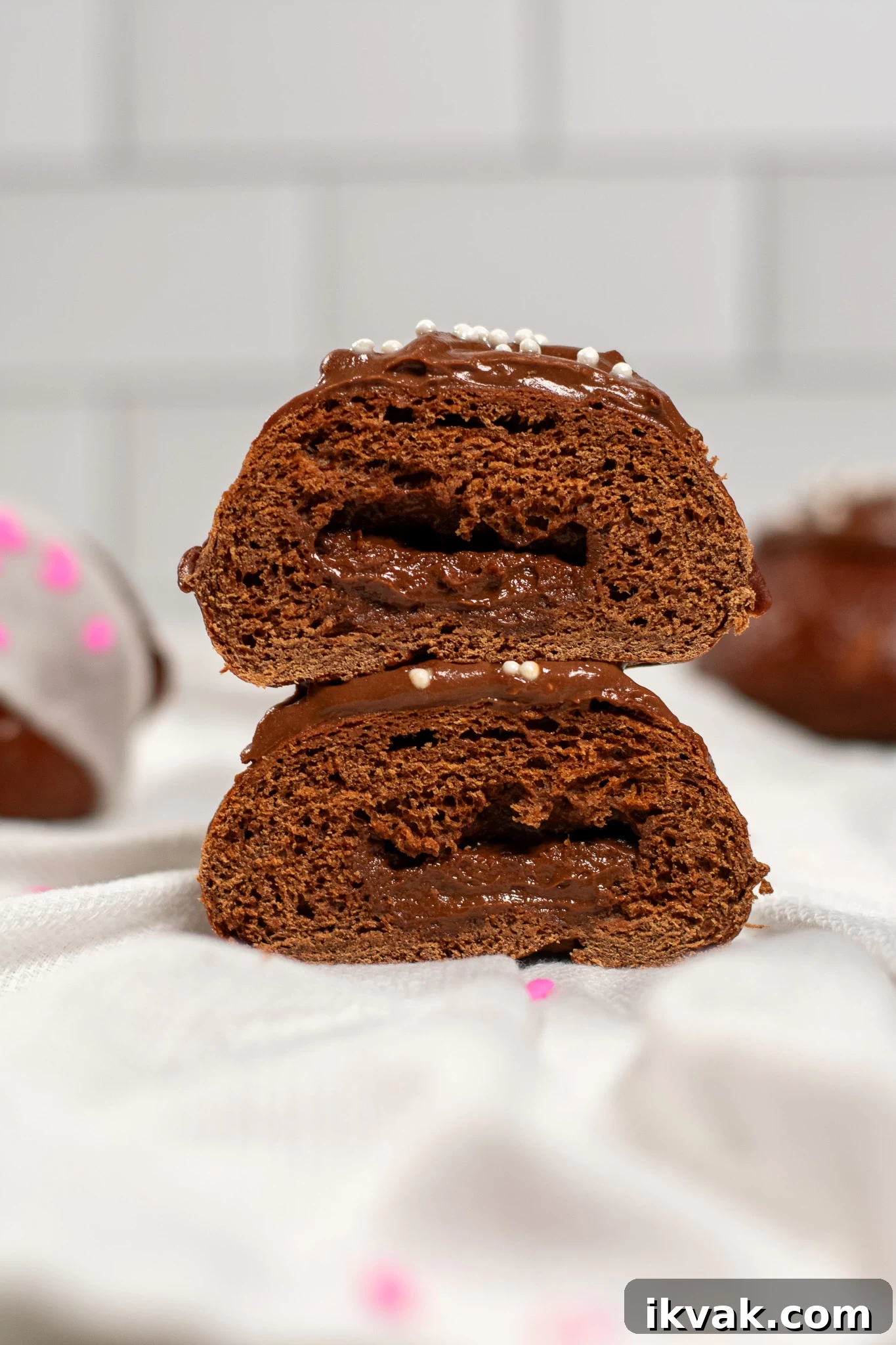 Chocolate Fastelavnsboller: How to Make Danish Carnival Buns 4 A cross section of a chocolate pastry cream filled chocolate bun.
