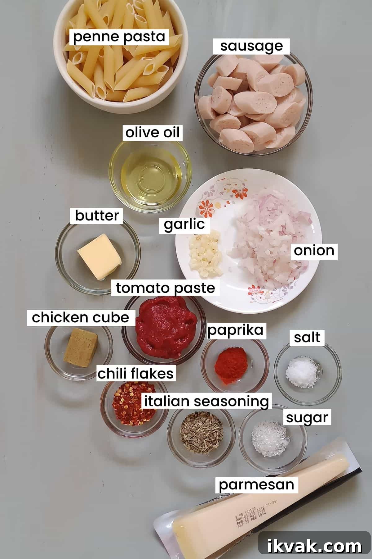 Image showing sausage pasta ingredients placed on a grey background.