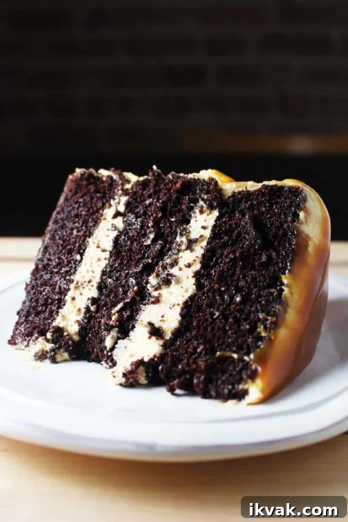 Slice of caramel chocolate cake on a plate with coconut caramel frosting and caramel drizzle 