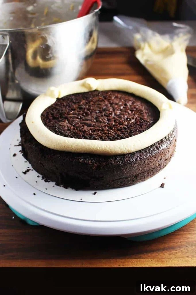 Chocolate cake layer with piped frosting dam - how-to for frosting a caramel chocolate cake 