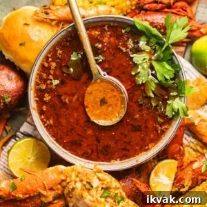 seafood boil sauce in a bowl with a spoon.