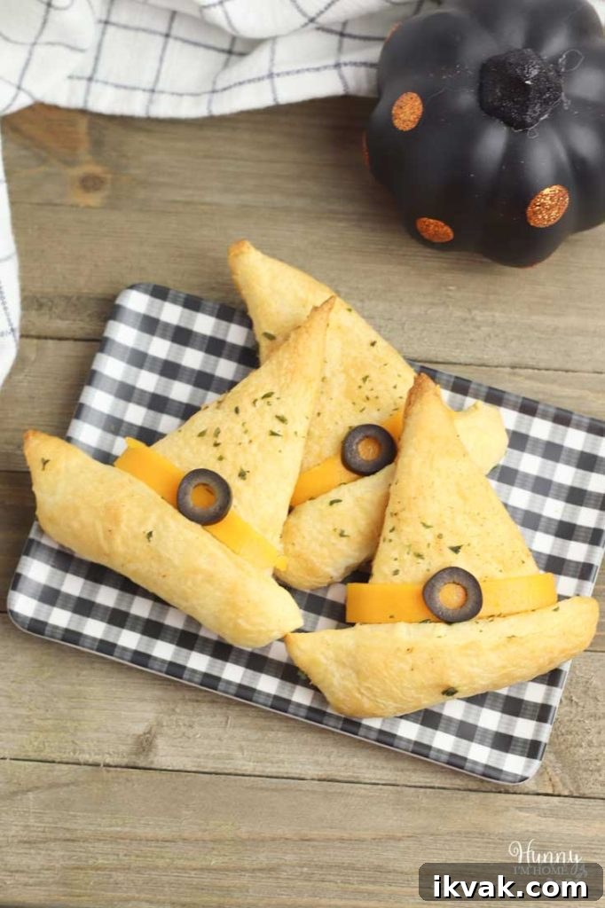27 Spooky Halloween Appetizers Adults Will Love 21 19. Witch Hat Garlic Bread