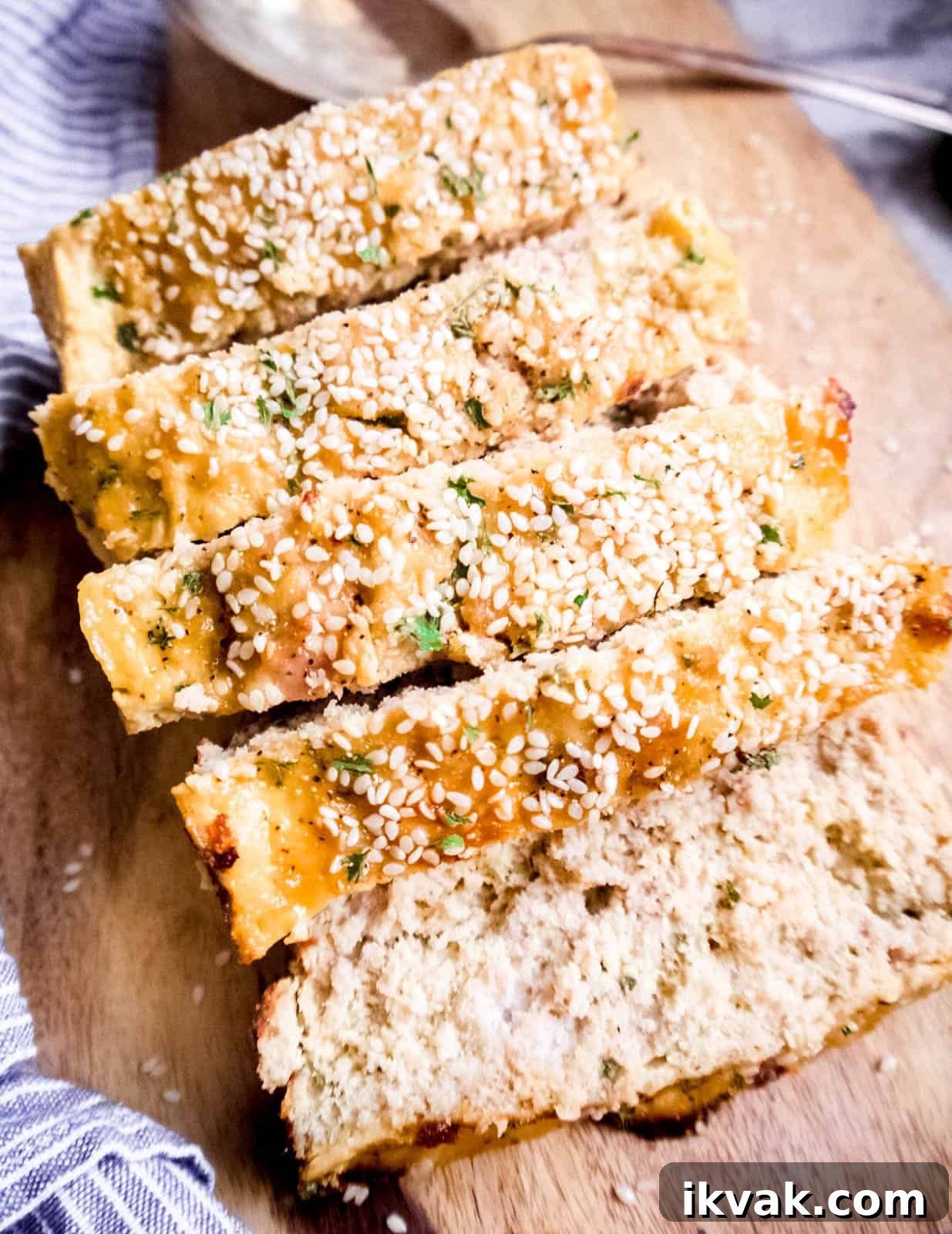 Paleo Turkey Meatloaf with Honey Sesame Glaze 5 Sliced honey sesame paleo meatloaf on a cutting board.
