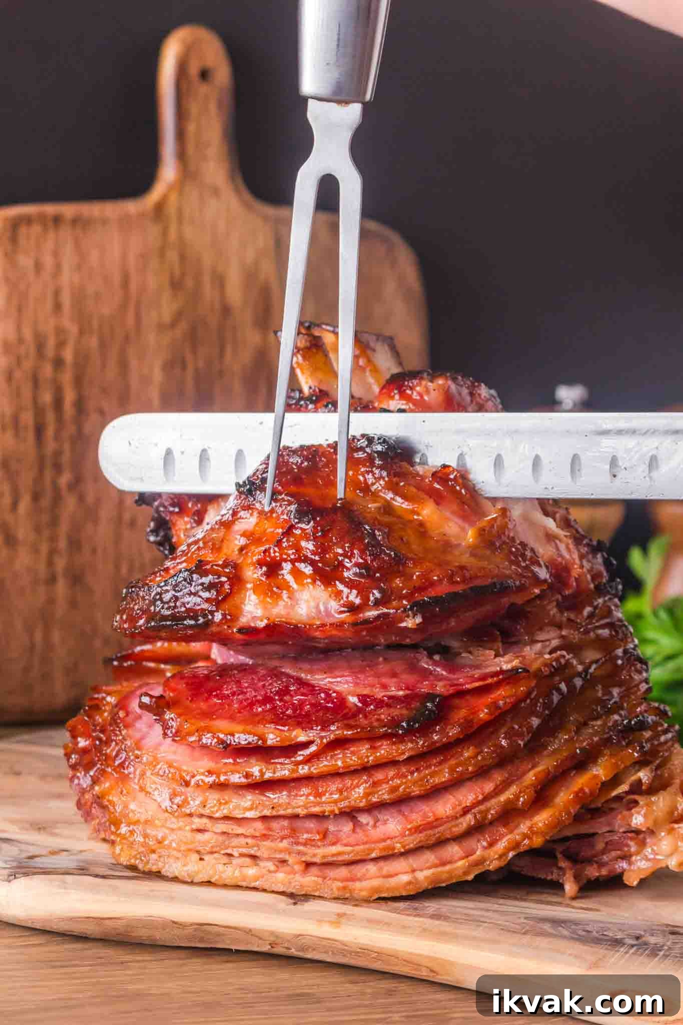 Honey-Baked Ham with Brown Sugar Glaze Recipe 8 Whole honey baked ham on wooden cutting board ready to slice showing caramelized exterior - Hostess At Heart