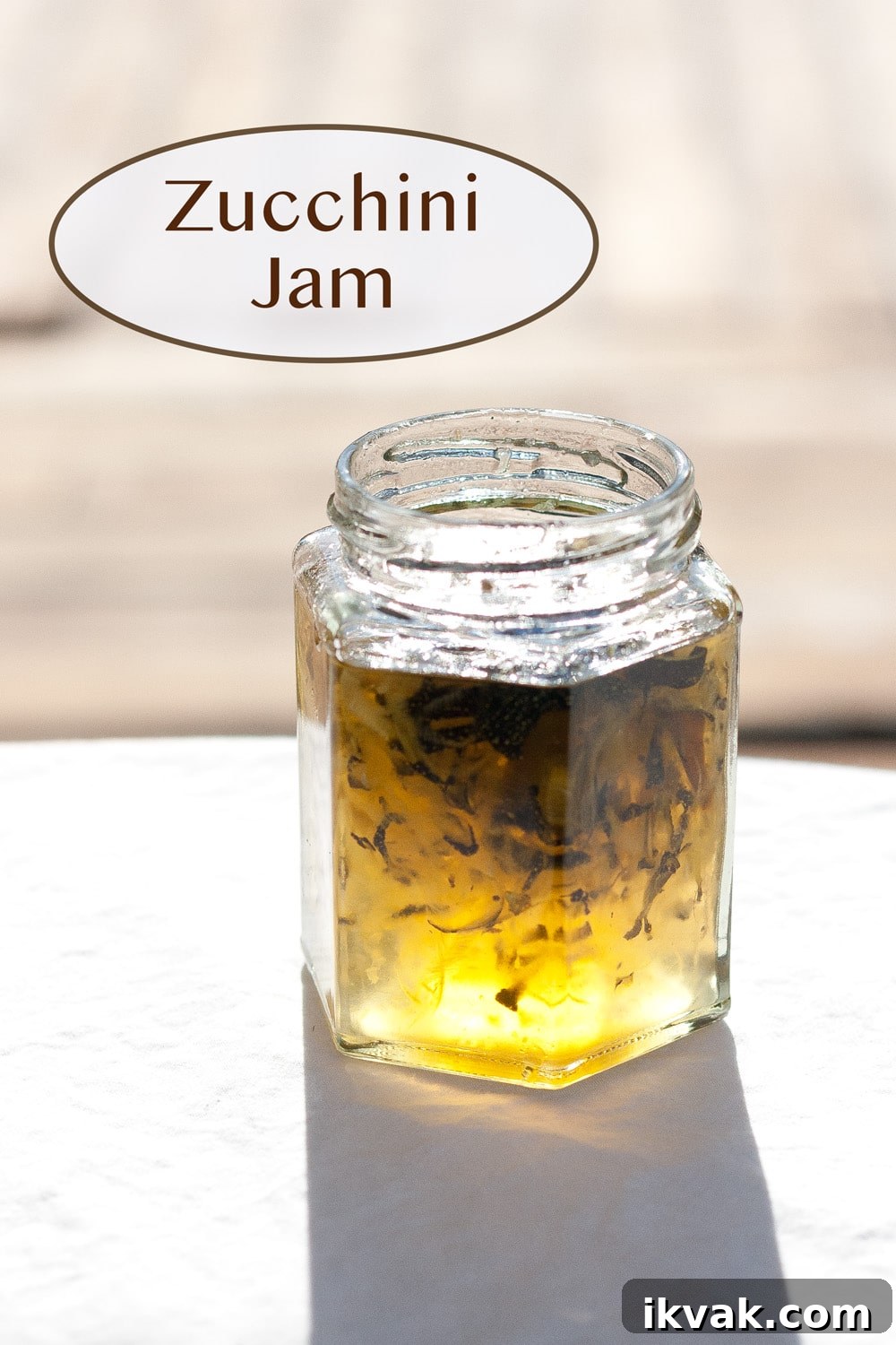 How to Make Zucchini Jam: Sweet Homemade Recipe and Tips 2 a small jar fille with jam and the sunlight is coming through so you can see the yellow color shine.