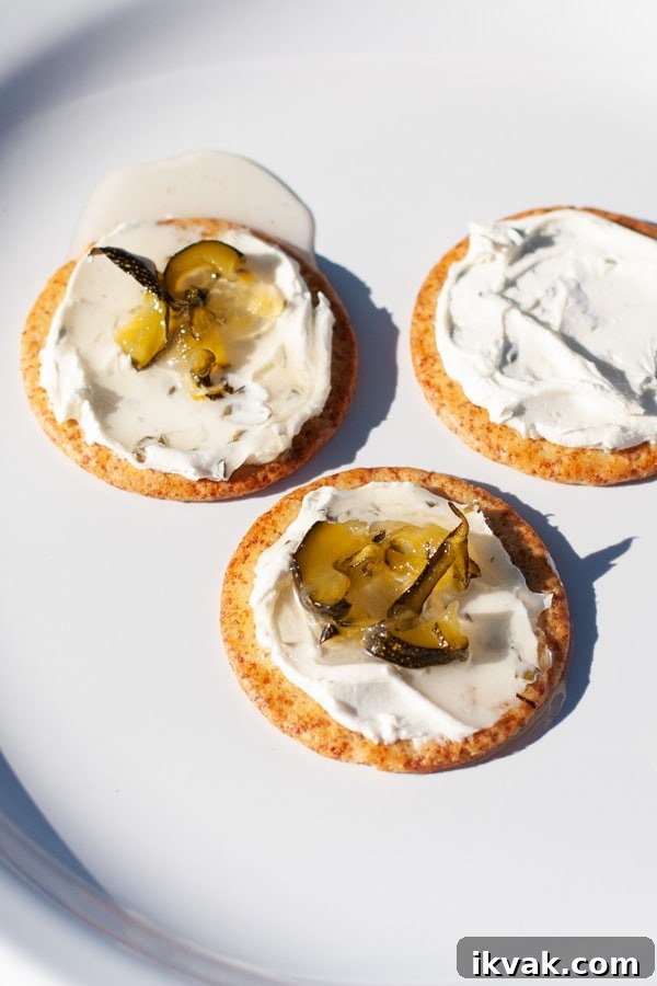 How to Make Zucchini Jam: Sweet Homemade Recipe and Tips 4 three crackers with cream cheese and jam on them.