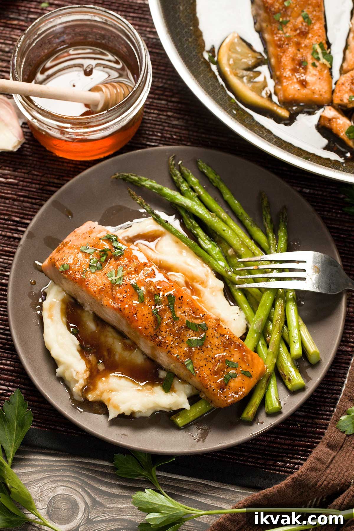 Honey Garlic Pan-Seared Salmon in a HexClad Skillet 4 Mashed potatoes, asparagus and salmon on a plate.