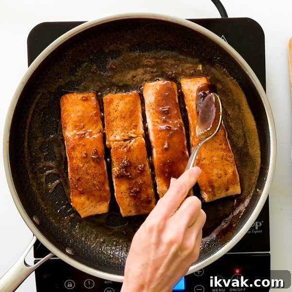 Honey Garlic Pan-Seared Salmon in a HexClad Skillet 10 Basting salmon with the honey garlic butter sauce.