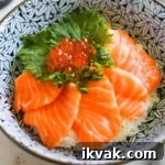Closeup of salmon sashimi rice bowl with Ikura.