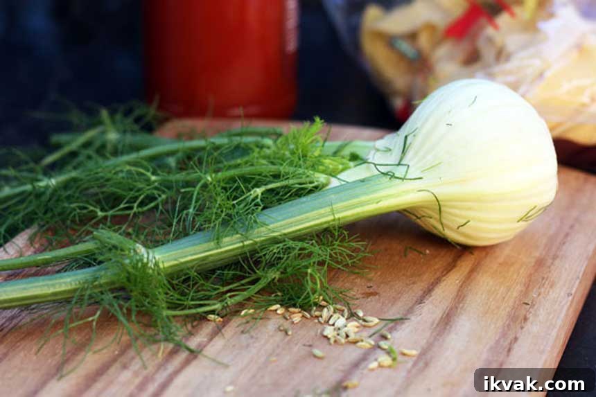 20 Flavorful Dill Substitutes for Cooking and Garnish 4 A bulb of fresh fennel complete with fronds on a wooden chopping board with other ingredients in the background.