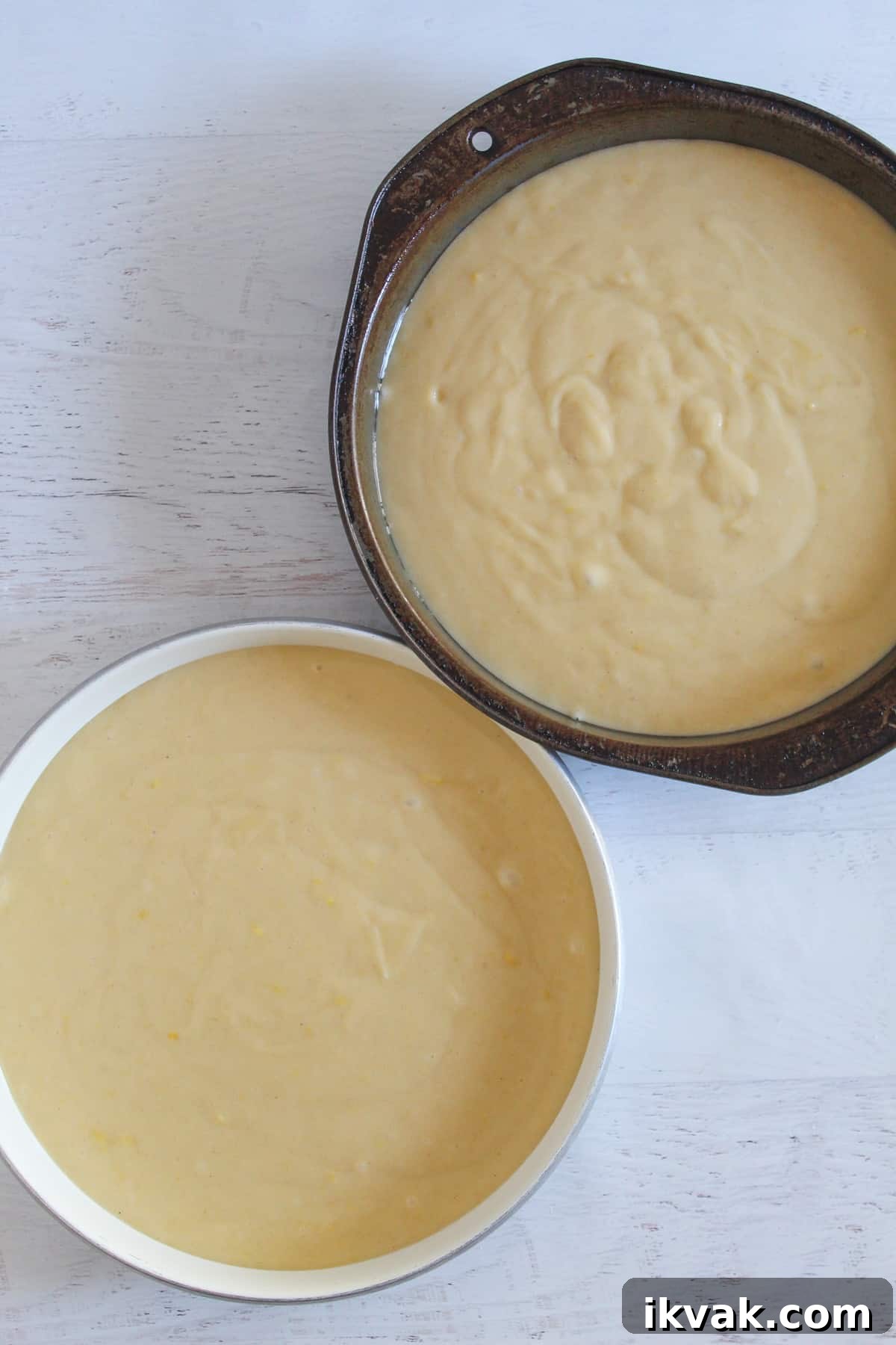lemon cake batter left to rise in two cake pans