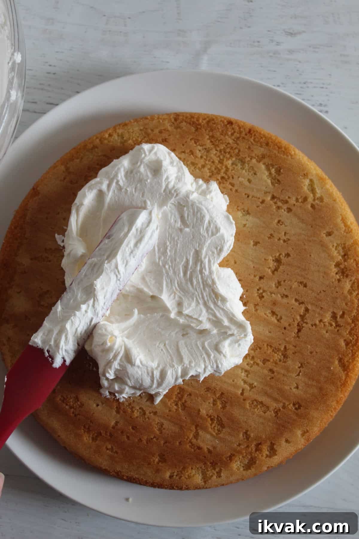 a dollop of frosting on the bottom cake 
