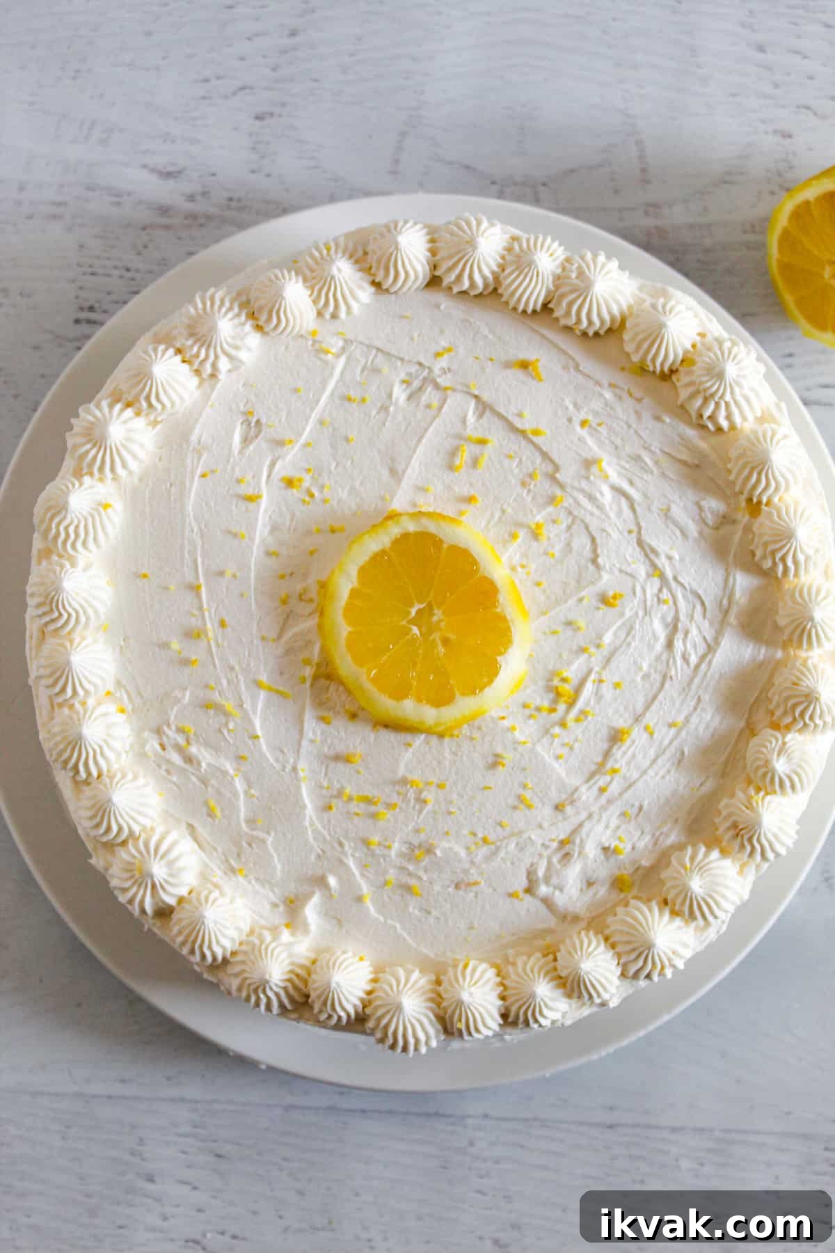overhead shot of a whole frosted gluten free lemon cake.