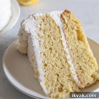 slice of gluten free lemon cake on a white plate.