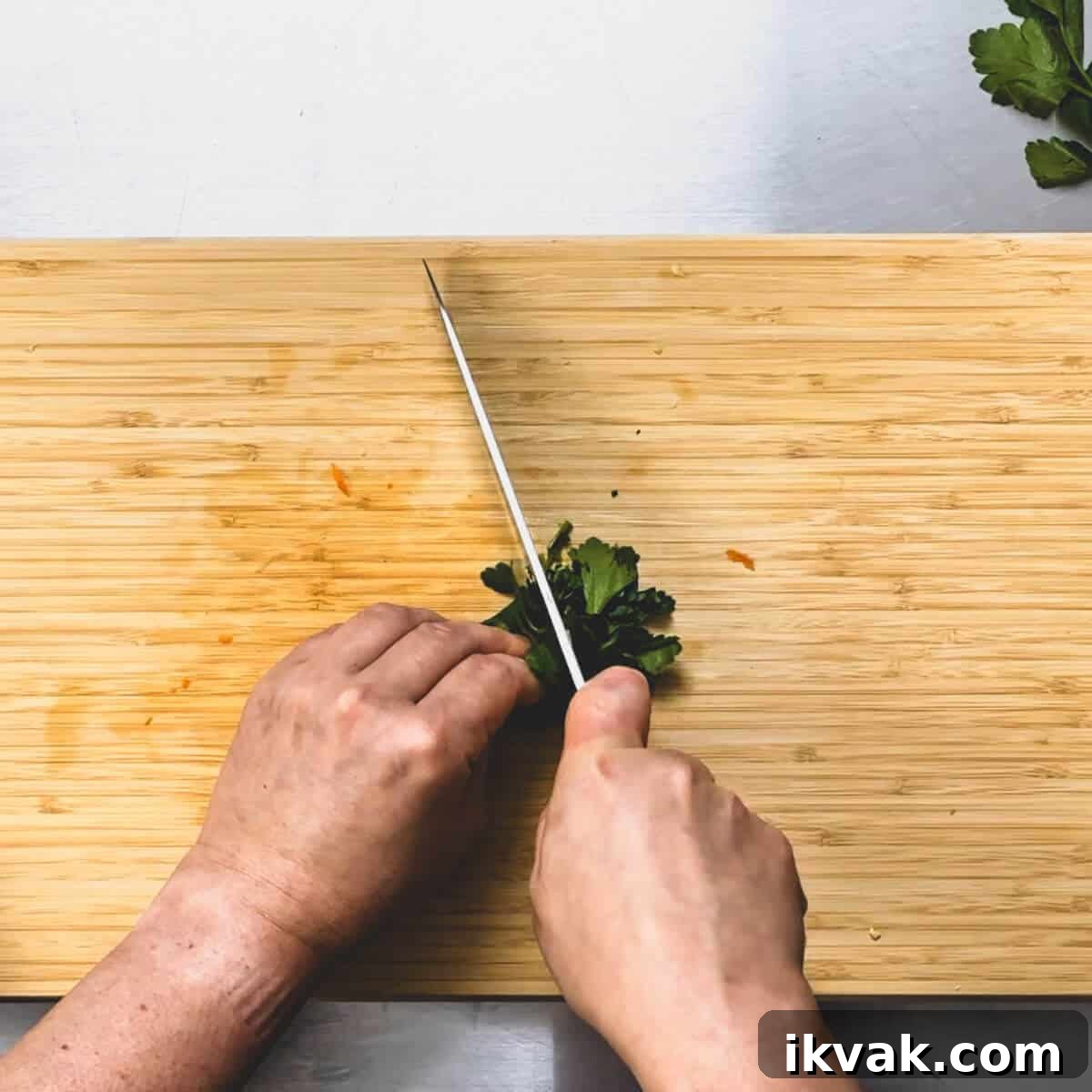 parsley being shredded on a chopping board.
