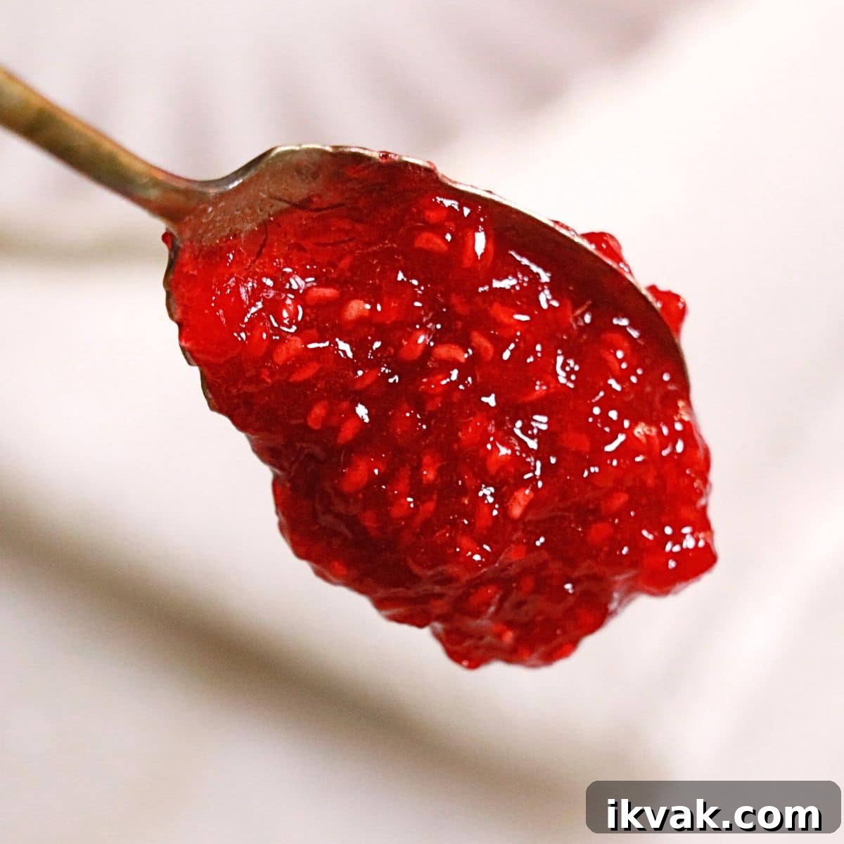 homemade raspberry jam on a spoon