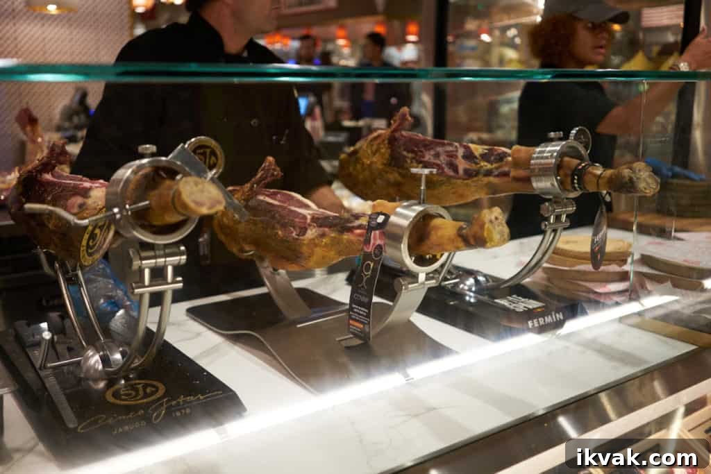 Legs of Spanish jamón on metal stands ready to be sliced.