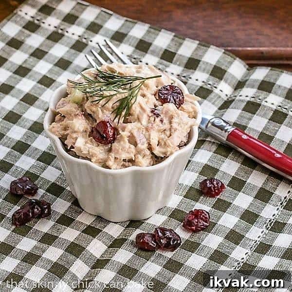 Tuna, Cranberry, Pecan Salad Sandwich - a quick lunch recipe for a delicious change of pace! Tuna, Cranberry, Pecan Salad Sandwich in a small white ramekin